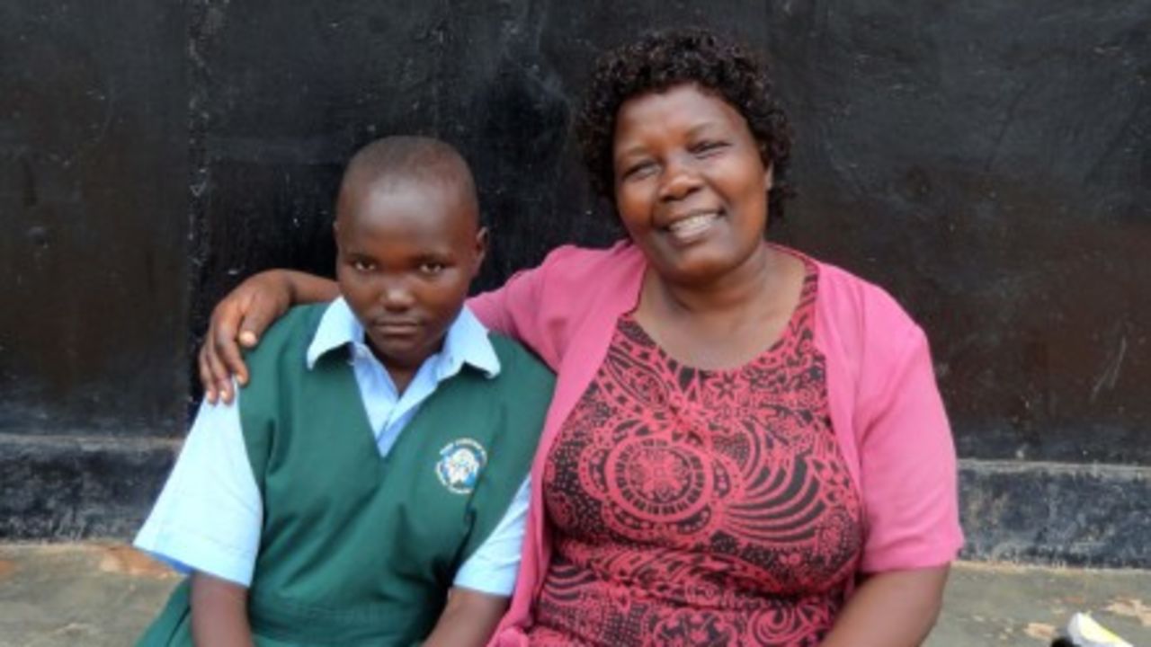 Kalibala with one of the children she supports in Uganda. - (Courtesy Galadys Kalibala)